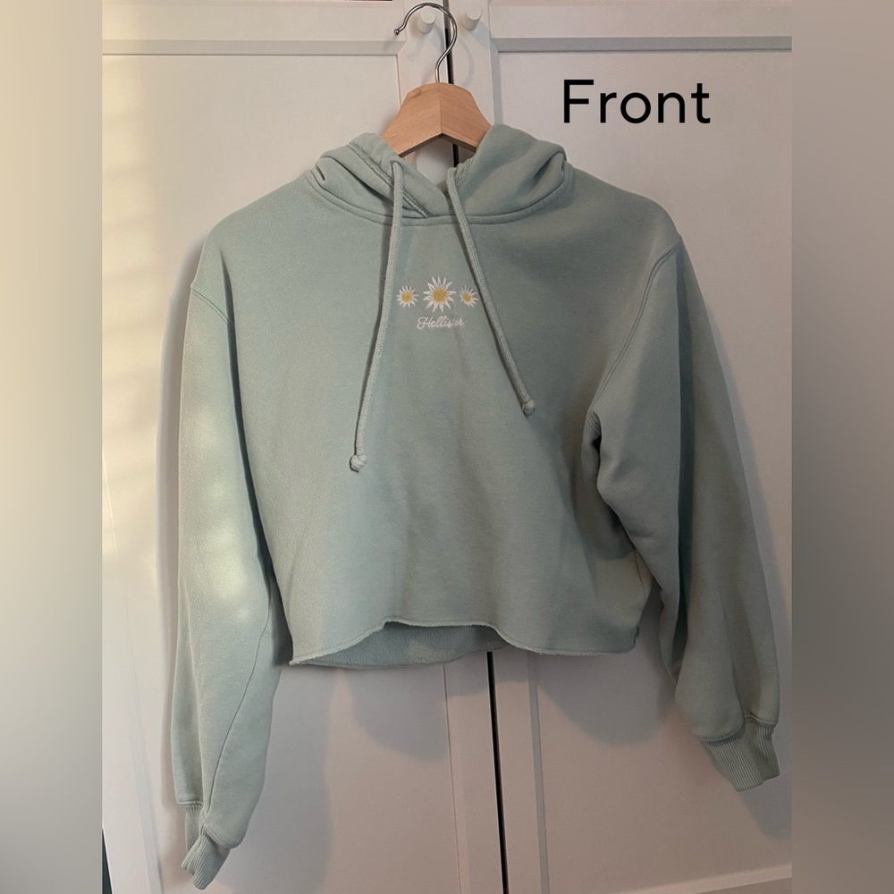 This is a cropped green sunflower hoodie and is from Hollister.